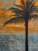 Palm tree silhouette against an orange sunset sky with water reflection