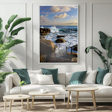 Living room with a white sofa, teal and white pillows, and a framed beach scene on the wall.