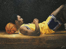 Mosaic artwork of a basketball player lying on the ground with a basketball next to him.