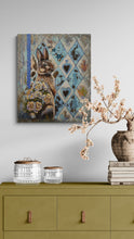Decorative painting of a rabbit on a wall above a green cabinet with decorative items.
