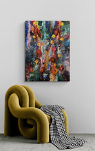 Abstract painting on a wall above a modern green chair with a checkered blanket.