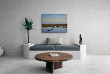 Modern living room with a gray sofa, wooden coffee table, and a large wall-mounted canvas print.
