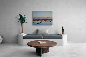 Modern living room with a gray sofa, wooden coffee table, and a large wall-mounted canvas print.