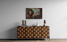 Wooden sideboard with decorative items and a painting on a gray wall.