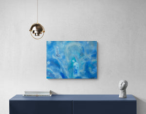 Blue abstract painting on a white wall above a dark blue console table.