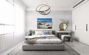 Modern bedroom with a bed, desk, and decorative elements.