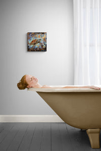 Woman lying in a bathtub with a painting on the wall above her